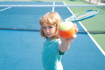 Kid boy at the tennis competition. Child practicing tennis forehand.