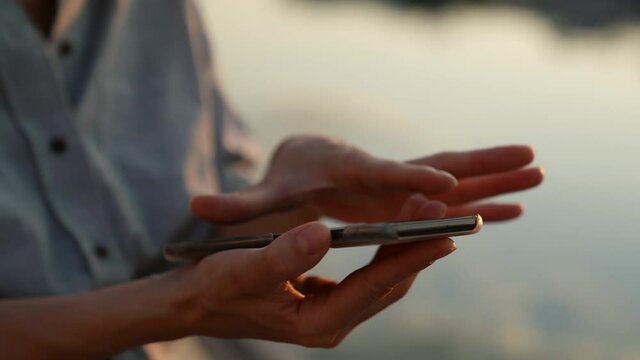 The modern concept of the wireless technology user. Close-up of women hands holding a smartphone