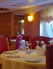 Formal elegant restaurant dining room onboard luxury cruiseship or cruise ship liner with set...