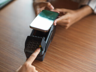 Top view of using payment terminal via smartphone QR code scanning