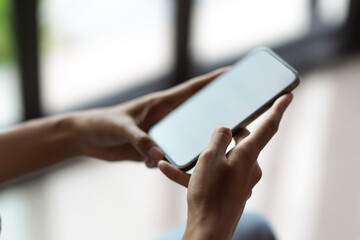 Close up female hands browsing internet via smartphone