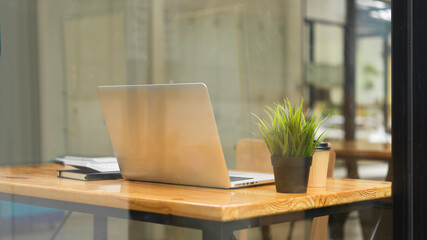Perfect co-working space for business people and student with laptop, plants, coffee cup, stuff at cafe