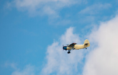 An old biplane flies overhead. Side view. Aerial concept.