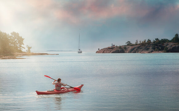 
Sportive woman canoeing in the sea