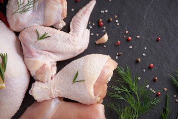 fresh chicken meat portions for cooking and barbecuing with stir fry with legs and wings with skin viewed from above with fresh seasoning,Raw chicken wings, Raw uncooked chicken leg on cutting board