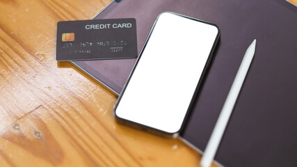 Smartphone mock up blank screen with credit card on wooden table, Cashless society