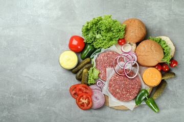 Concept of cooking burger on gray textured table