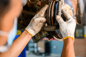 auto repair service changing car brake pads From the old brake pads, change to new brake discs and check the car's suspension. for safety in driving at the car repair station © เลิศลักษณ์ ทิพชัย