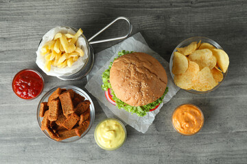 Tasty fast food on gray textured table