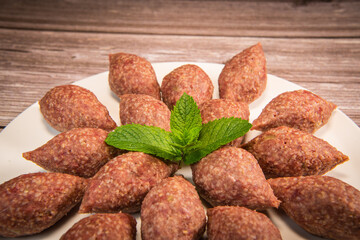 Traditional kebbe and pita bread on big round plate in lebanese restaurant. High quality photo