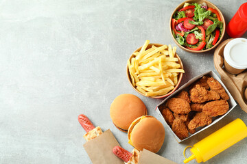 Tasty fast food on gray textured table