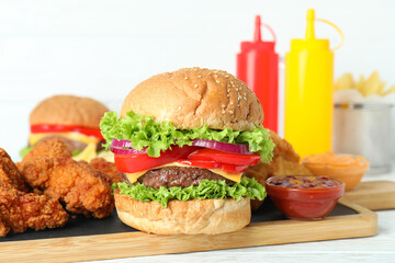 Concept of fast food on white wooden table