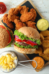 Concept of fast food on white wooden table