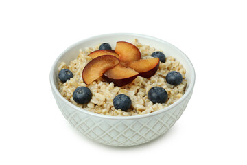 Bowl of oatmeal with tasty ingredients isolated on white background