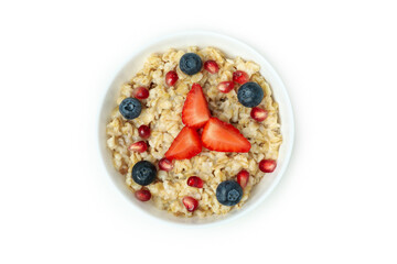 Bowl of oatmeal with tasty ingredients isolated on white background
