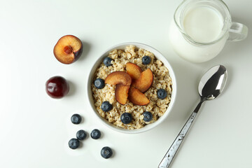 Concept of tasty eating with oatmeal on white background