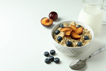 Concept of tasty eating with oatmeal on white background