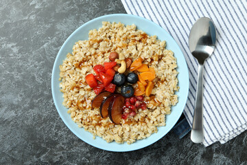 Concept of tasty eating with oatmeal on black smokey background