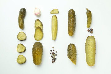 Fresh pickles and spices on white background