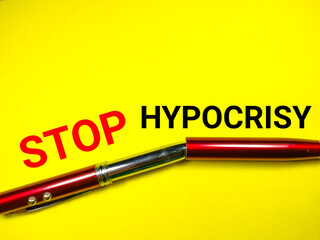Fototapeta premium News concept.Text STOP HYPOCRISY with red pen on a yellow background.