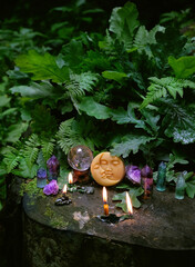 symbolic moon, candles, minerals, magic crystal ball in forest, natural background. meditation, relaxation, Witchcraft concept. healing gemstone. spiritual ritual for cleaning aura. wiccan witch altar