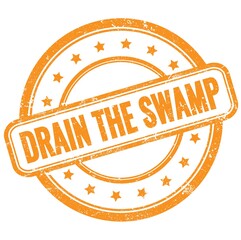 DRAIN THE SWAMP text on orange grungy round rubber stamp.
