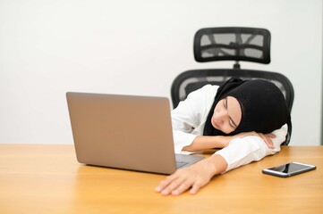 girl sleeping at home desk next to computer Close your eyes from exhaustion after work.