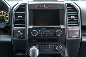 Modern car interior with multimedia display and dashboard. View from inside a car