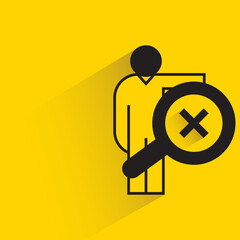 man holding magnifier with wrong mark on yellow background