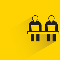 office worker working on laptop on yellow background