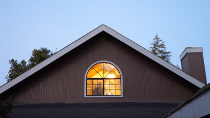 Fototapeta na wymiar house at dusk with person inside; blue hour