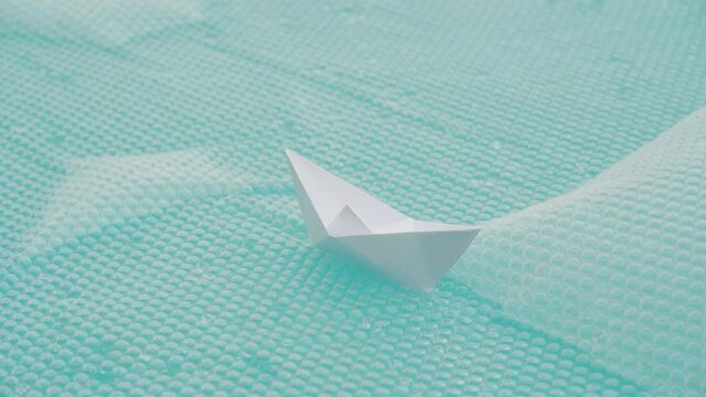 Paper Boat On A Plastic Bubblewrap Floating On A Pool. close up