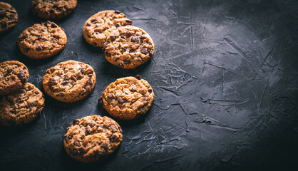 Homemade chocolate chip cookies on a dark table. Ready to eat.
