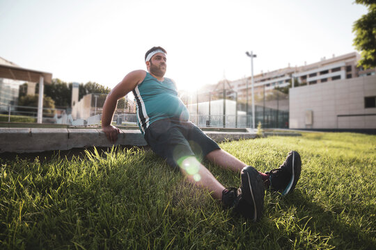a young man exercising in an outdoor park.
willpower.