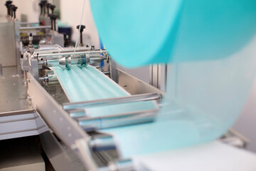 Industry and factory concept, medical face mask production line.