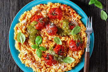 creamy tomato risotto with pesto, top view