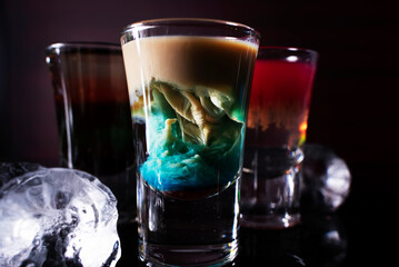 Cocktail shots on black background. Cocktail at the bar.