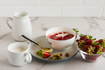 Tasty oatmeal with strawberry on table close-up