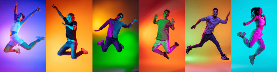 Fototapeta na wymiar Portrait of group of people jumping isolated on multicolored background in neon light, collage.