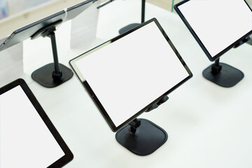 Blank monitor screens on a showcase in a shopping centre with copy space.