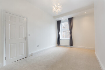 An empty modern room in an apartment with plain white walls