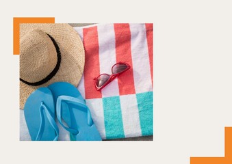 Photograph of flip flops, sunglasses and starfish against grey background