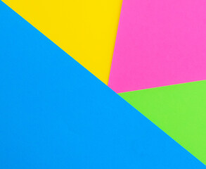 Multicolored paper geometric background. Colored paper pattern.