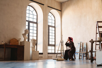 Young white woman painter in an art studio