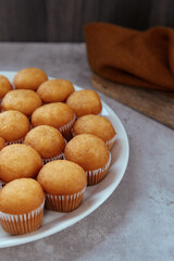 Obraz na płótnie Canvas freshly baked mini muffins on a white plate
