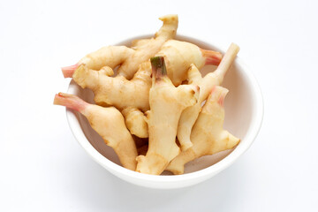 Young ginger in white bowl on white background.