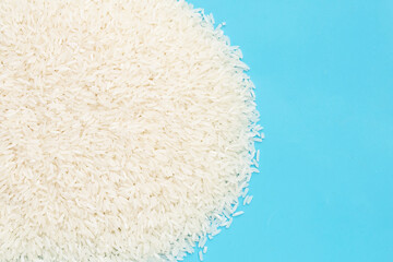 Raw rice on blue background.