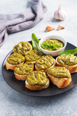 Sandwiches with pesto sauce, fresh basil leaves and garlic. A delicious healthy snack.