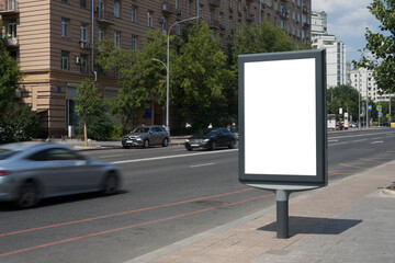 Blank advertising billboard in the city center next to the road. City format