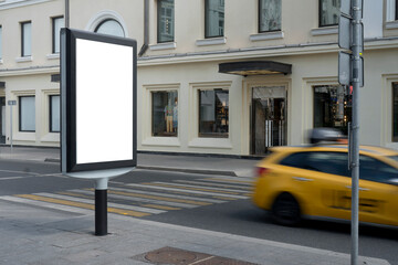 Blank advertising billboard in the city center next to the road. City format